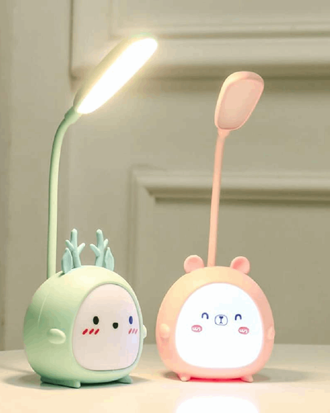 Two cartoon teddy bear-designed LED lamps, one green and one pink, with adjustable goosenecks, illuminated and displaying their respective RGB light modes.