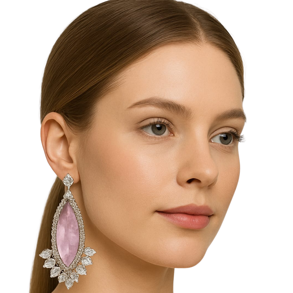 Close-up of a woman wearing a pink gemstone earring with a white background