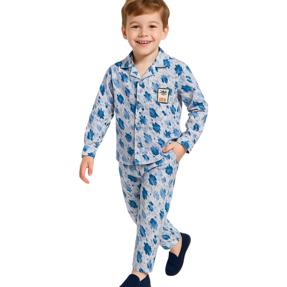 Child wearing a blue and white patterned pajama set on a white background