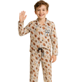Child wearing a patterned pajama set with a white background