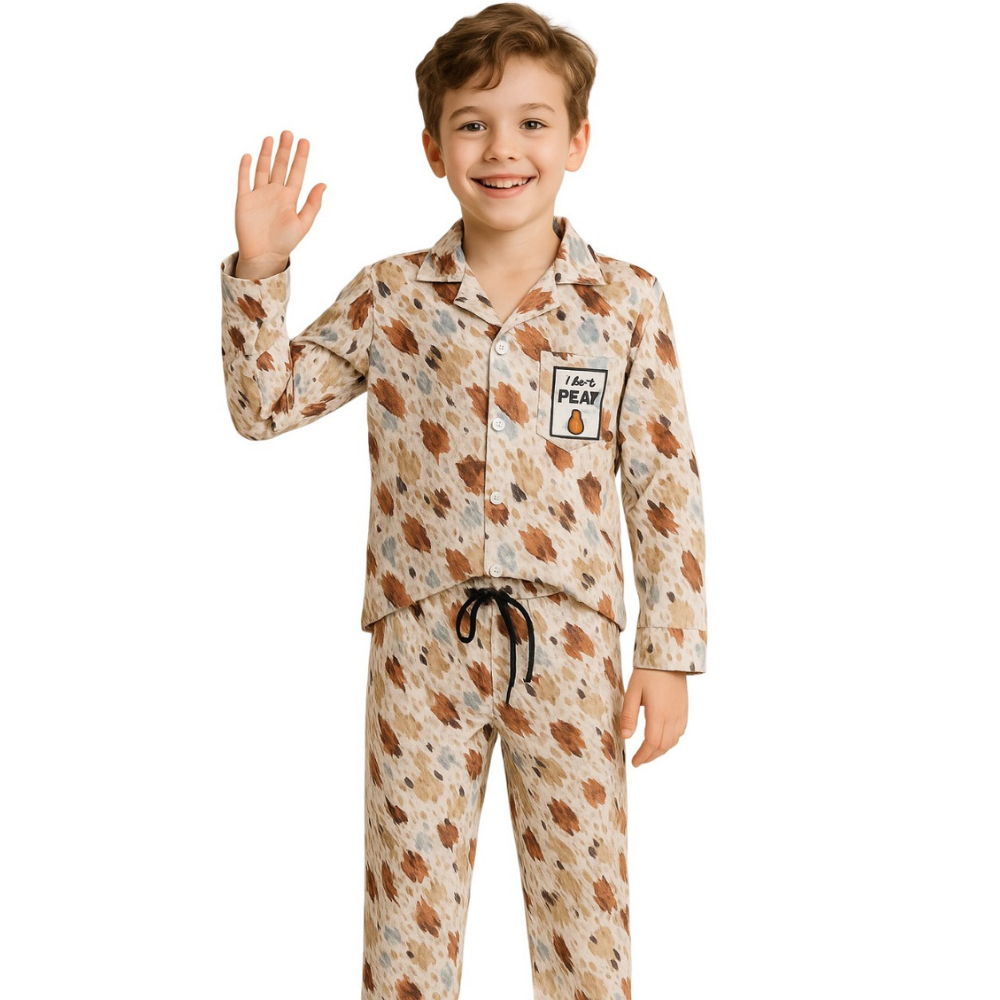 Child wearing a patterned pajama set with a white background