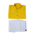 Yellow embroidered shirt and white pants on a white background