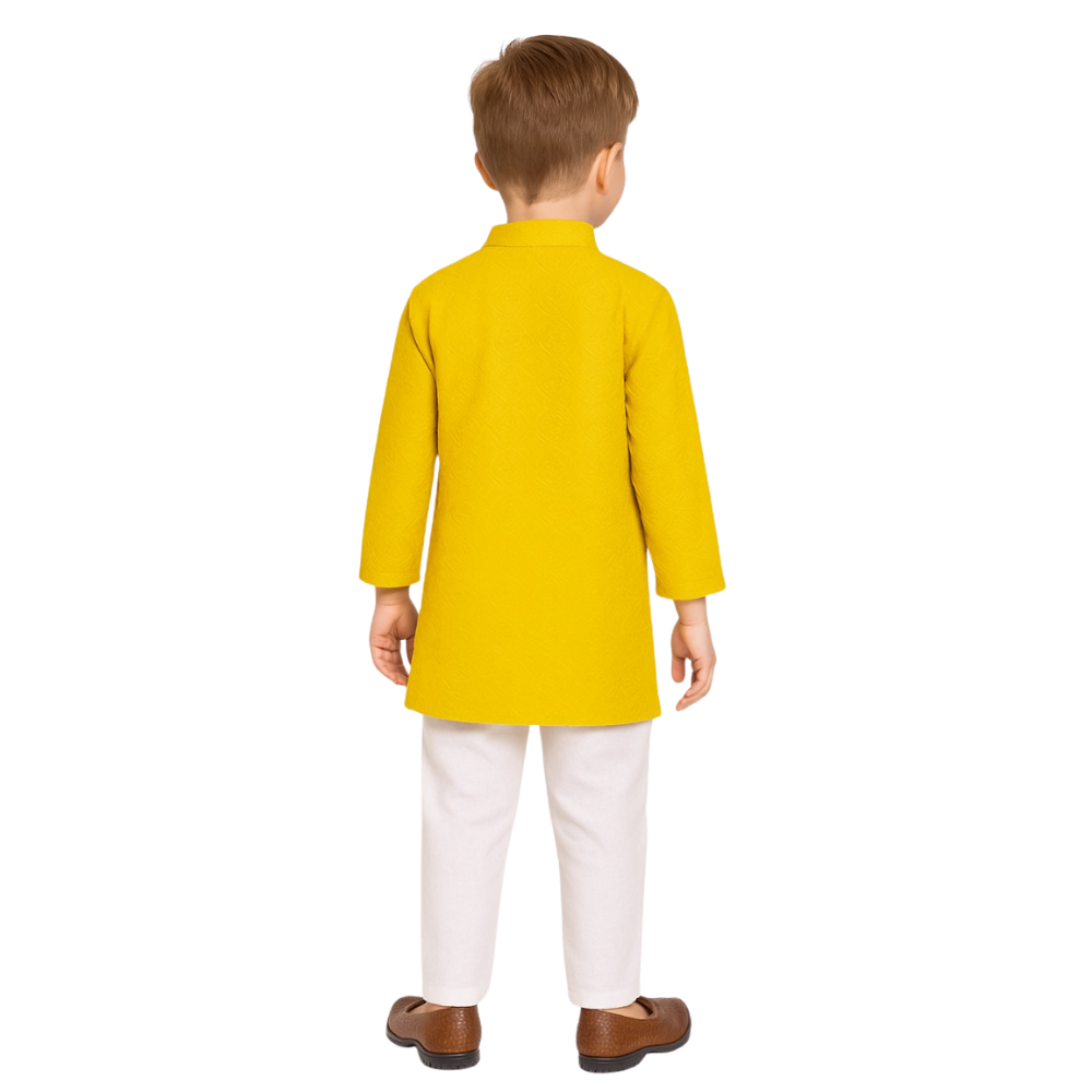 Child wearing a yellow kurta with white pants on a white background