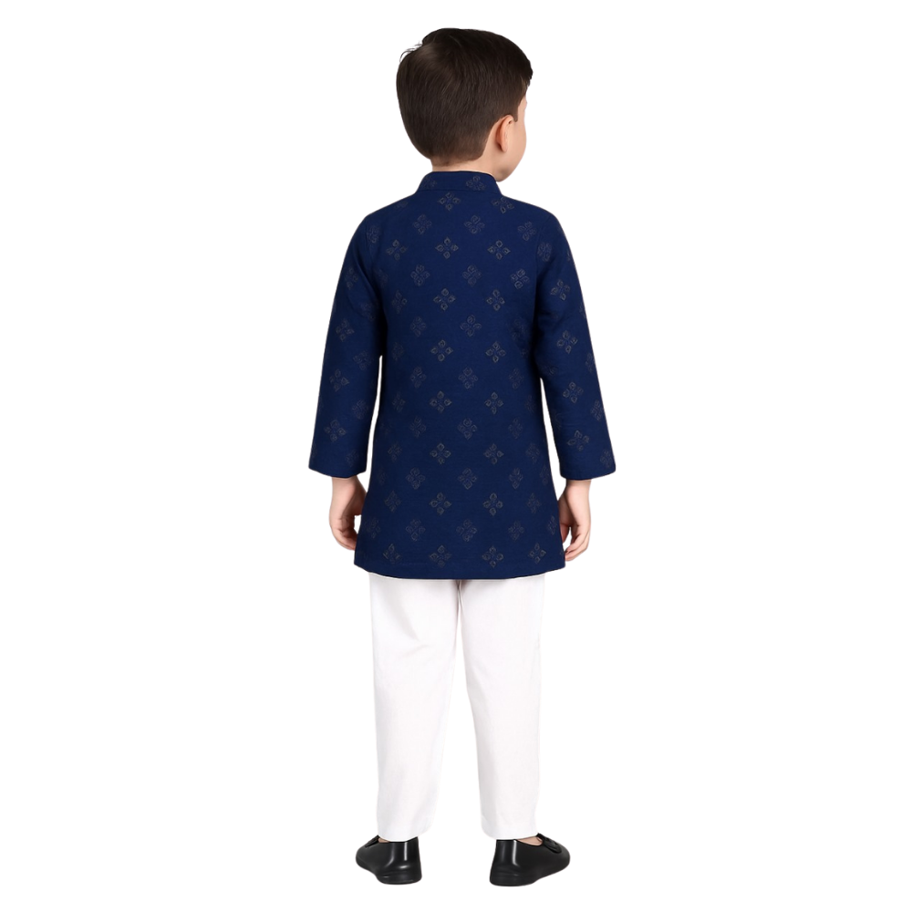 Child wearing a navy blue kurta with white pants on a white background