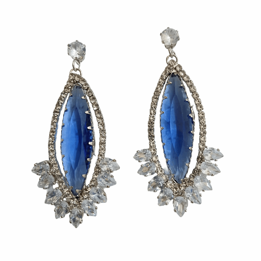 Woman wearing a blue teardrop earring with a white background