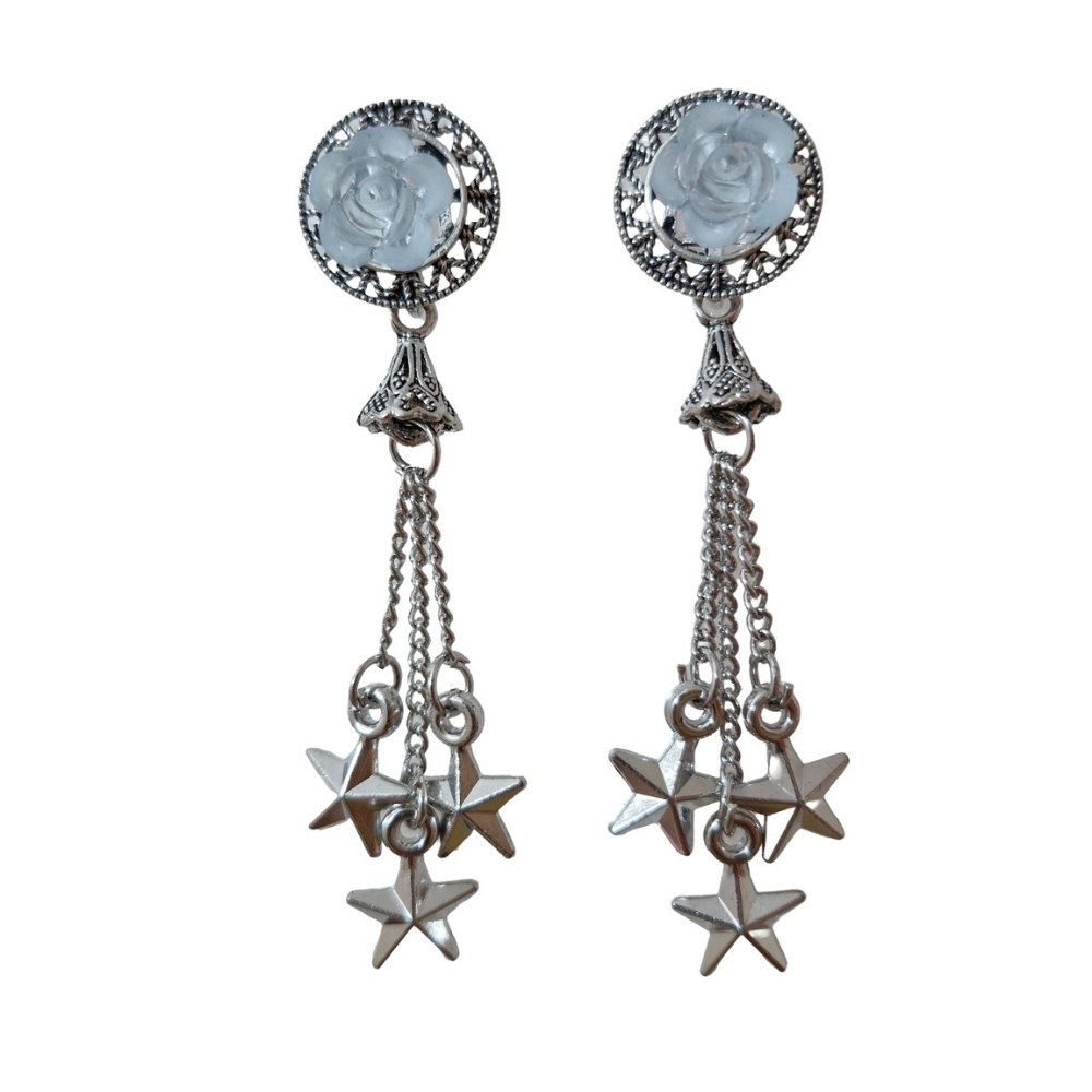Woman wearing elegant earrings with a neutral background