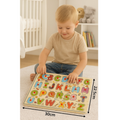 Child playing with a wooden alphabet puzzle in a nursery setting