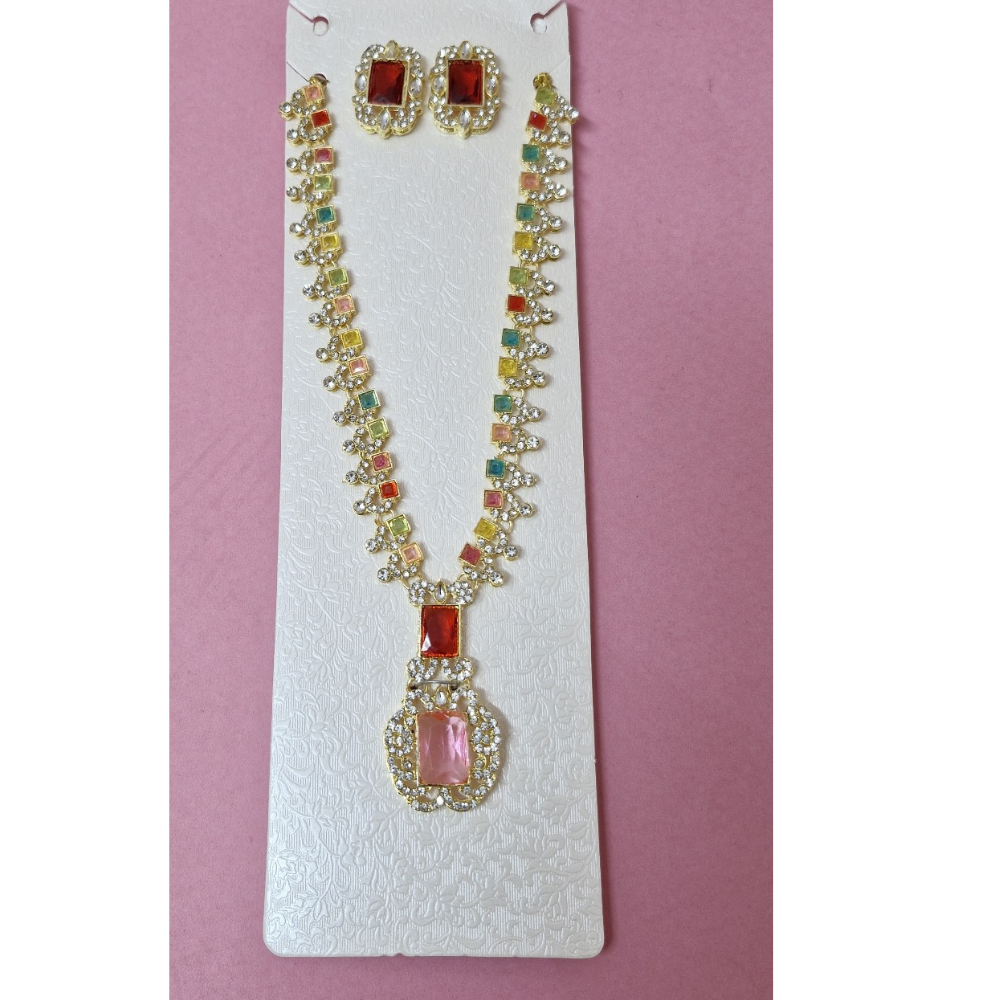 Necklace and earrings set on a white card with a pink background