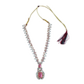Necklace with pink gemstone pendant and tassel on a white background