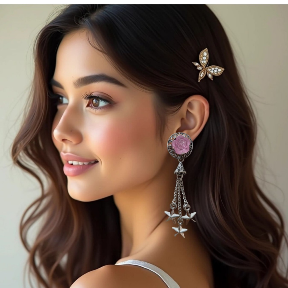 Woman wearing a butterfly hair clip and rose earrings with star charms.