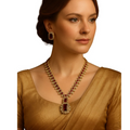 Woman wearing a gold necklace with red stones on a white background