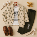 Fashionable outfit with beige patterned blazer, black pants, white t-shirt, and brown shoes on a neutral background.