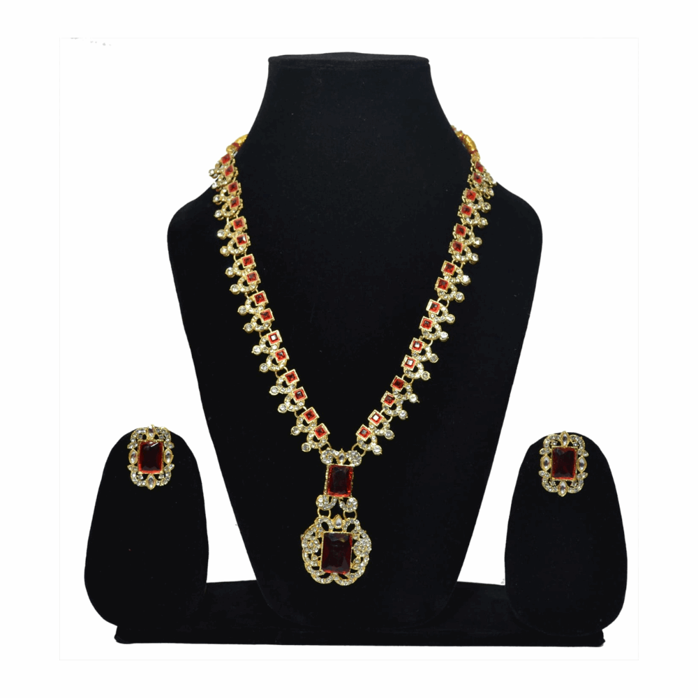 Woman wearing a gold necklace with red stones on a white background