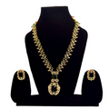 Gold and green necklace set on a black mannequin with earrings displayed.