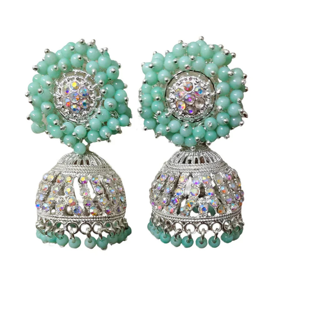 Close-up of a woman wearing green earrings 