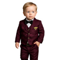 Child wearing a maroon suit with a bow tie on a white background