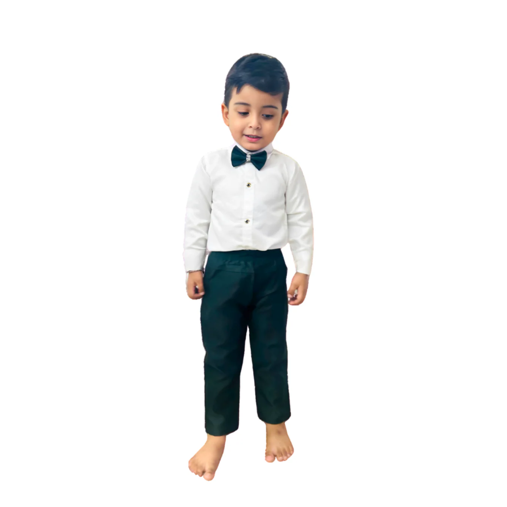 Child wearing a white shirt with a bow tie and black pants on a white background