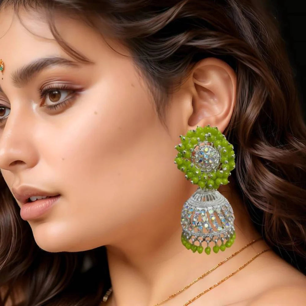 Close-up of a woman wearing green earrings 