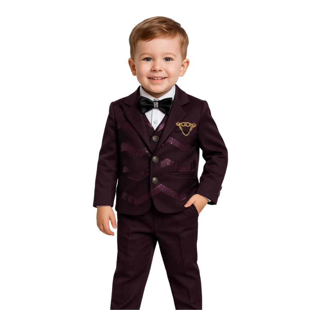 Young boy wearing a formal purple suit with a bow tie on a white background
